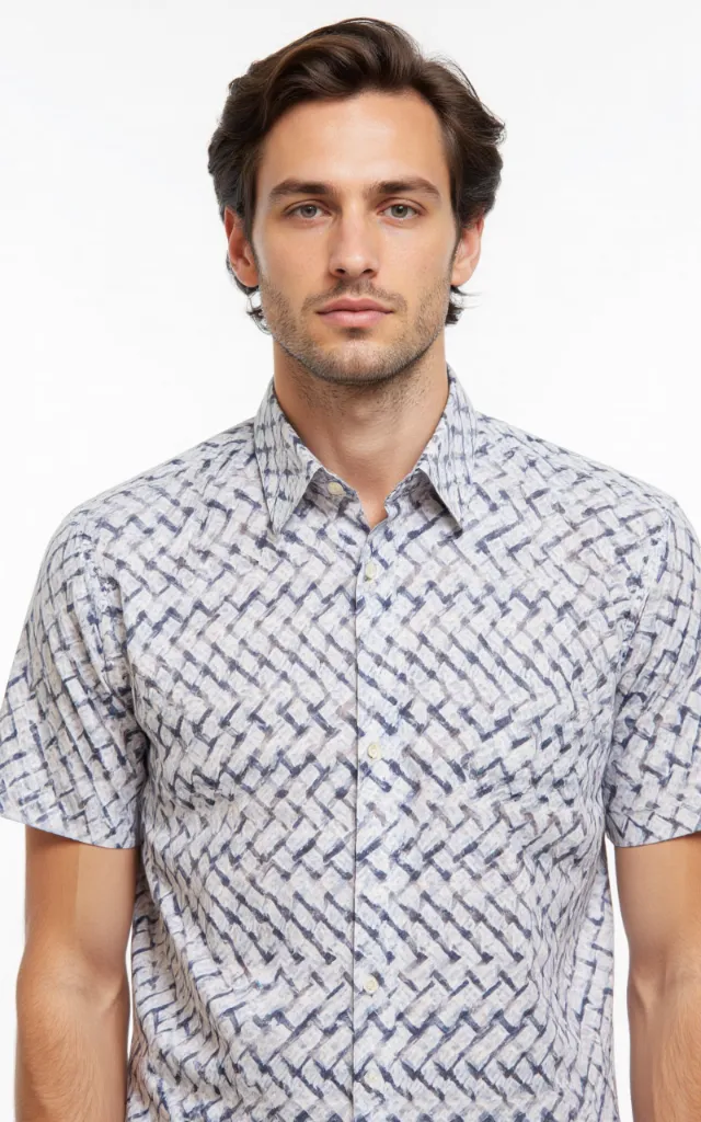 A French model wearing a Chevron pattern   printed shirt, against a white background, in a front   facing bust portrait